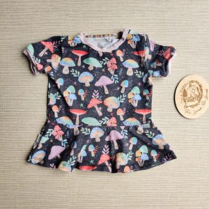 PRE-LOVED; RE-LOVED Age 6-12m Peplum T GUC Magical Mushrooms/Baby Pink with Poppered Neckline